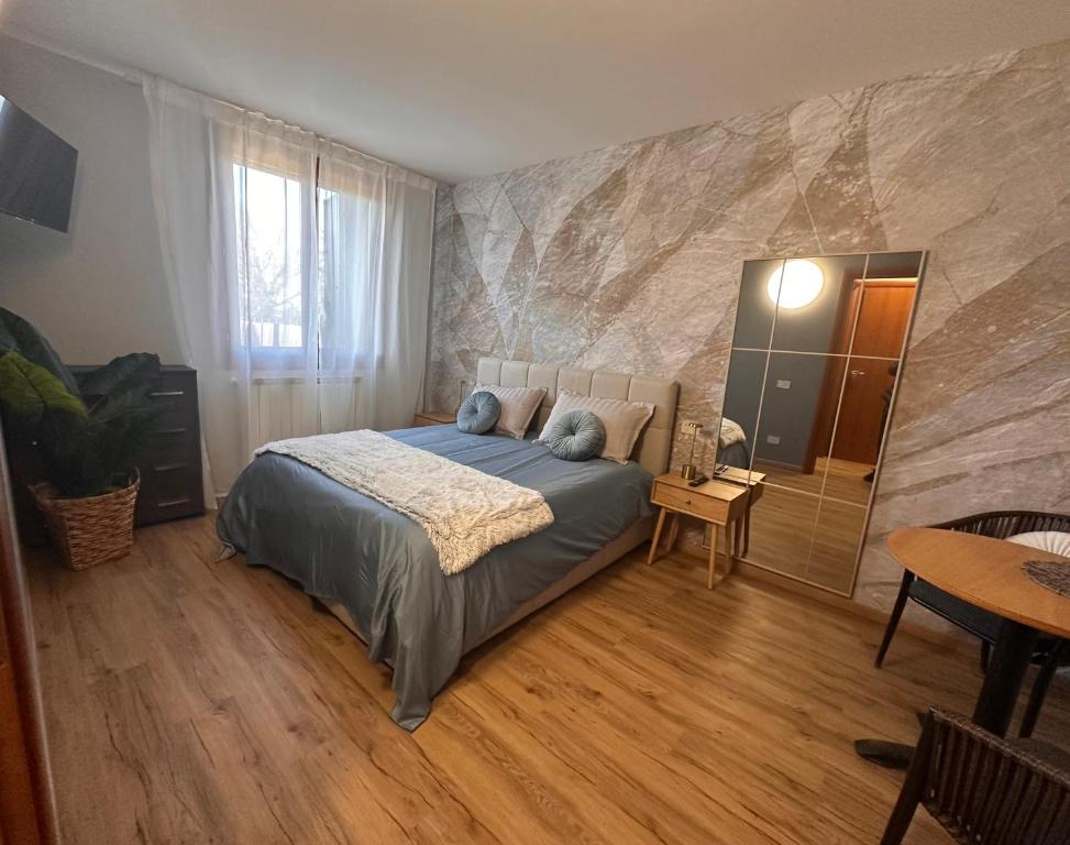 a bedroom with a bed with blue pillows on it at Elite in Rovigo