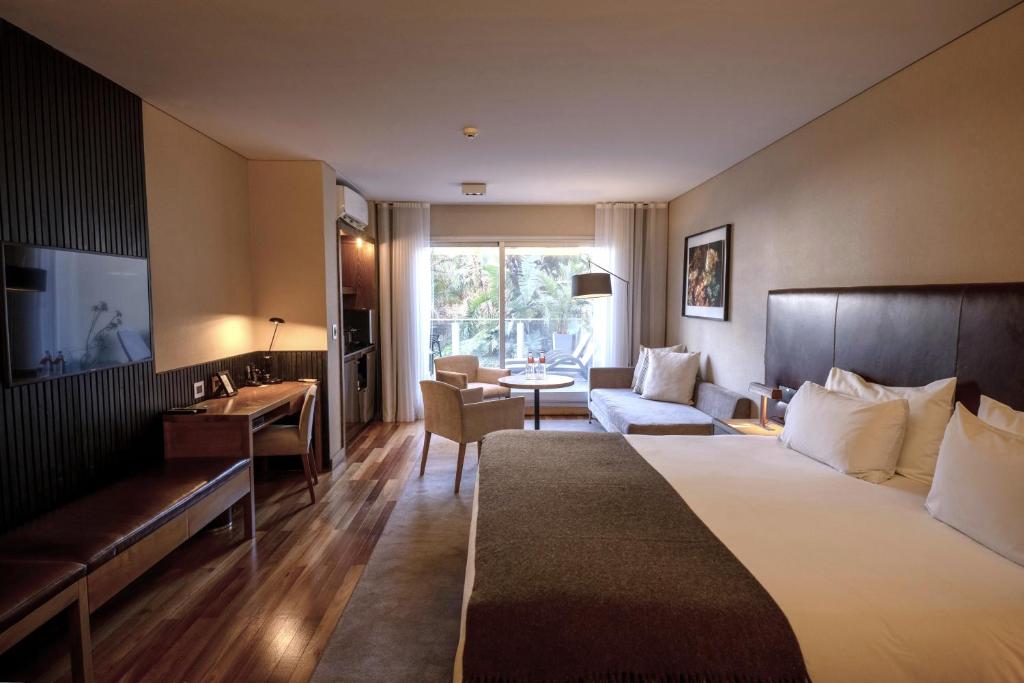 a hotel room with a bed and a living room at Fierro Hotel Buenos Aires in Buenos Aires