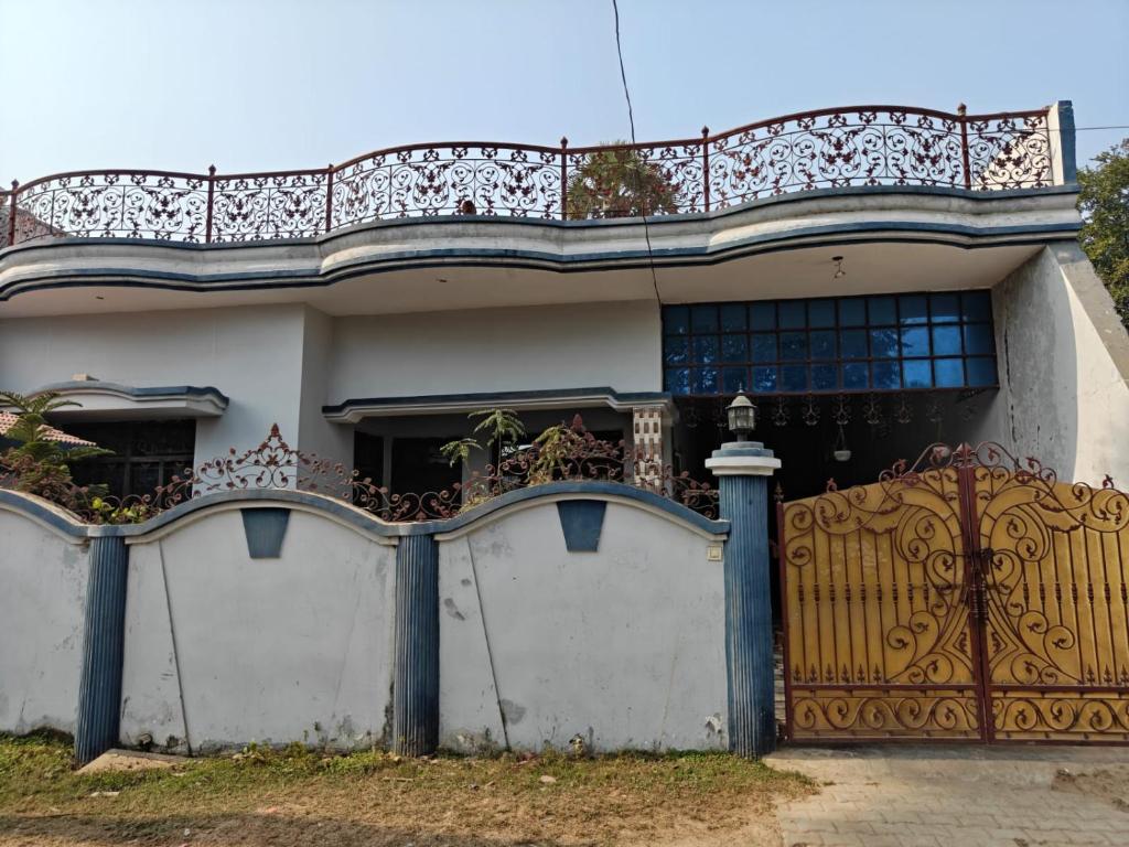 a house with a gate and a fence at Yamuna Bank Inn in Prayagraj