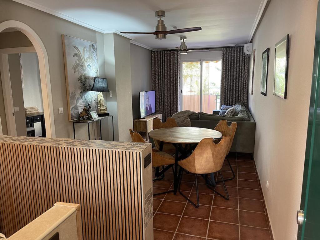 a living room with a table and chairs and a living room at Parque Vera 5 in Vera