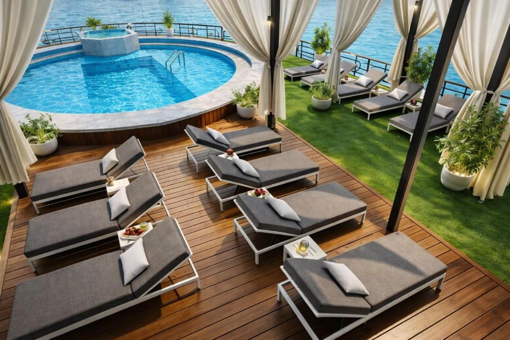 an overhead view of a swimming pool with lounge chairs at Five-Stars Deluxe River Kruz from Aswan to Luxor 3 Nights in Aswān