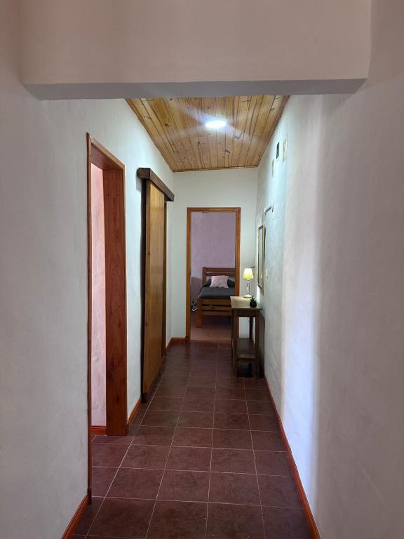 a hallway of a room with a room with a bed at Casa de Descanso Don Abel in Chascomús