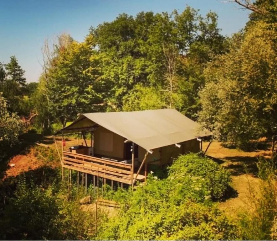 a gazebo with a canvas roof in a forest at Camping d'artagnan in Margouët-Meymès