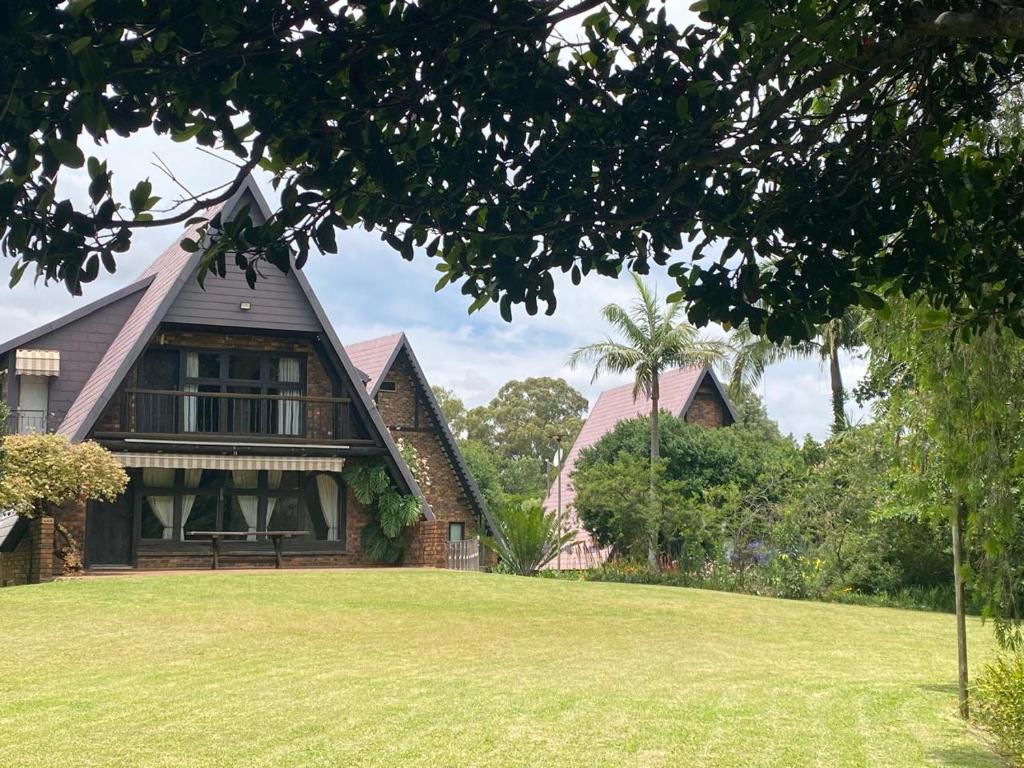 a house with a green lawn in front of it at The Swiss Garden in Midrand