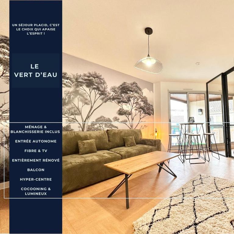 a living room with a couch and a table at Le Vert D'eau - Raffiné - Central - Balcon in Mont-de-Marsan