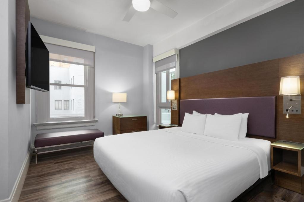 a bedroom with a large white bed and a tv at Cartwright Hotel Union Square - BW Premier Collection in San Francisco