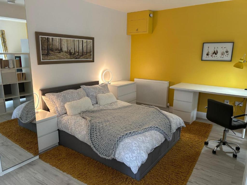 a bedroom with a bed and a desk and a desk at The Studio in Dunfermline
