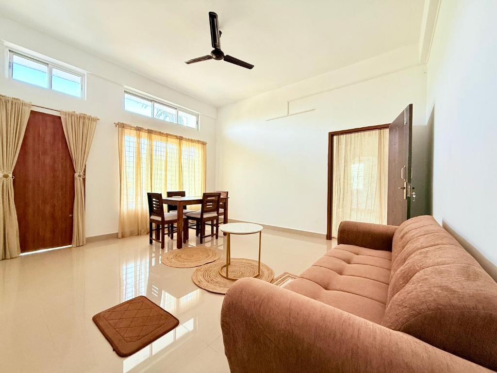 a living room with a couch and a table at Serenyaa in Dibrugarh