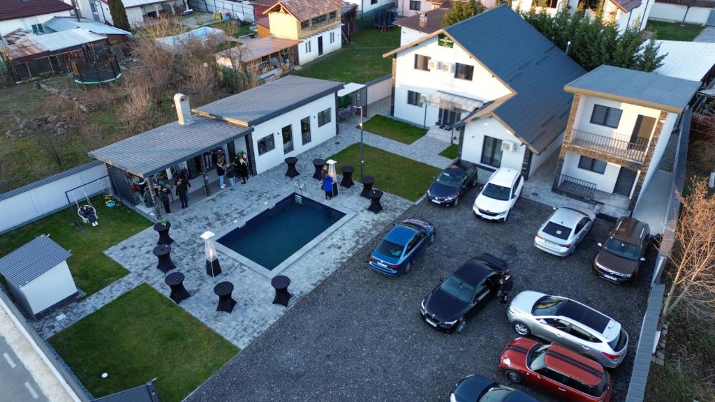 an aerial view of a house with cars parked in a parking lot at Stelele Oltului in Călimăneşti