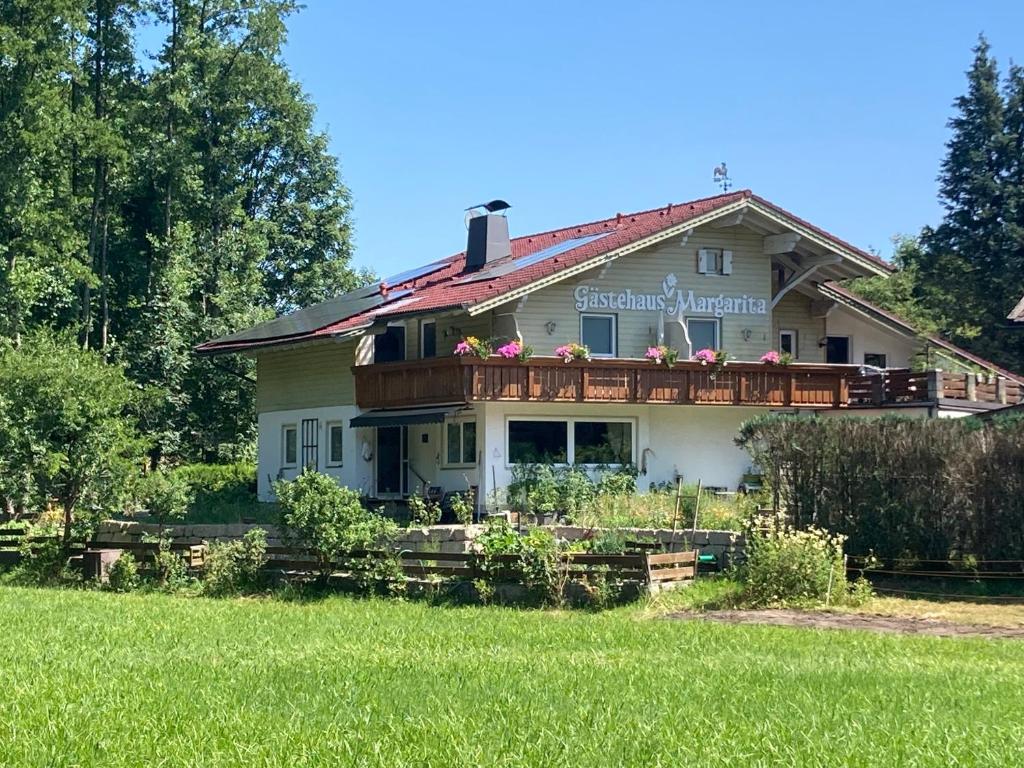 a large house with a deck on top of it at Gästehaus Margarita in Raubling