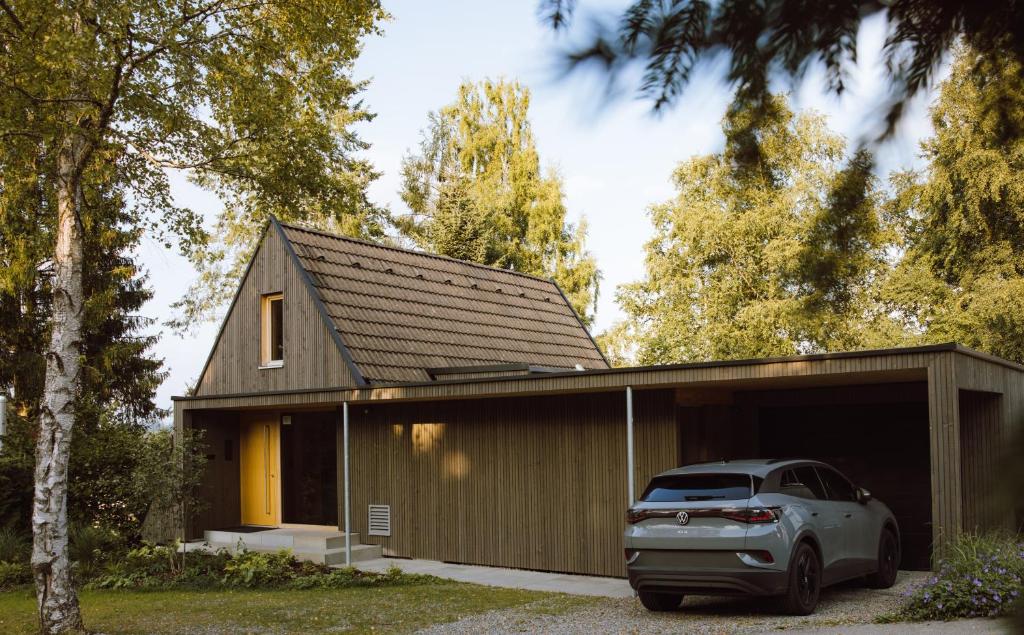 a small house with a car parked in front of it at HEIMATEL - A Huesle in Oberreute