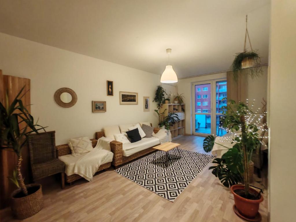 a living room with a couch and a table at Boho style apartment with garage and large terrace in Bratislava