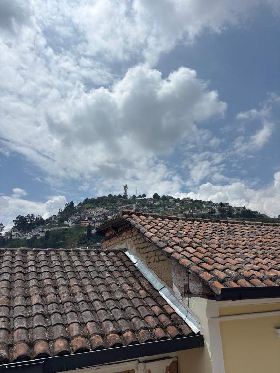 a roof of a building with a cross in the background at Casa La Ronda in Quito