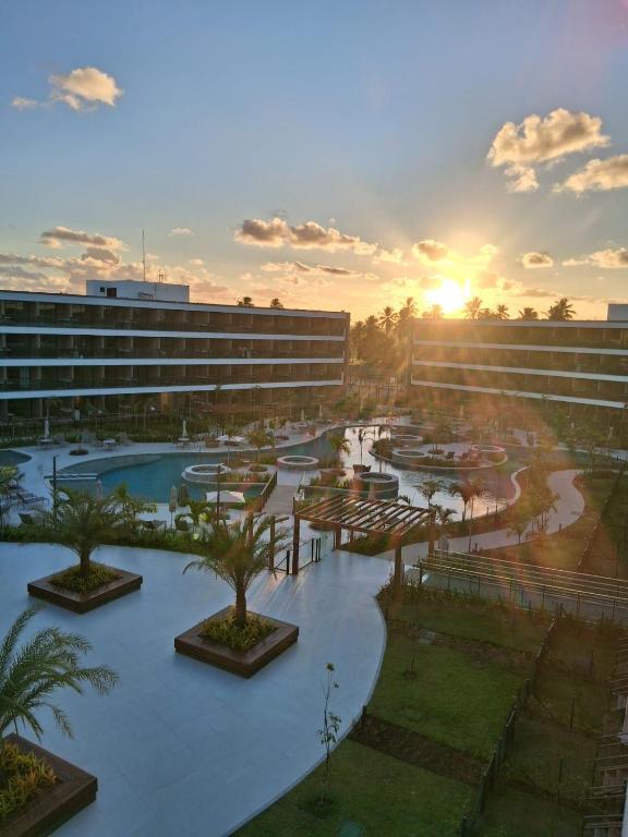 a view of a resort with a pool and a building at Beach Class Verano Flat 216 C in Porto De Galinhas