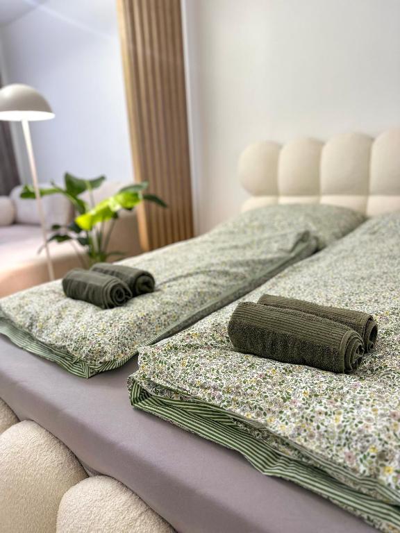two beds with pillows on them in a bedroom at Apartmán Sárka Brezno in Brezno