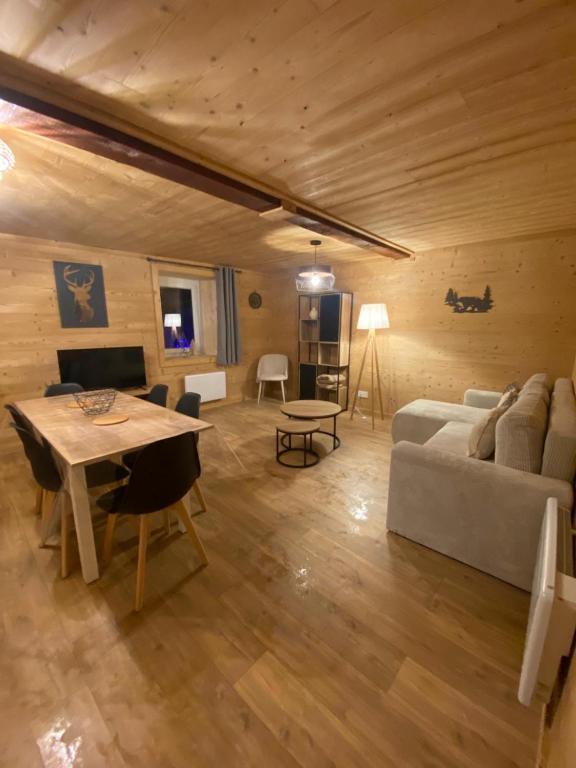 a living room with a couch and a table at Le Logis des Cerfs in Les Angles