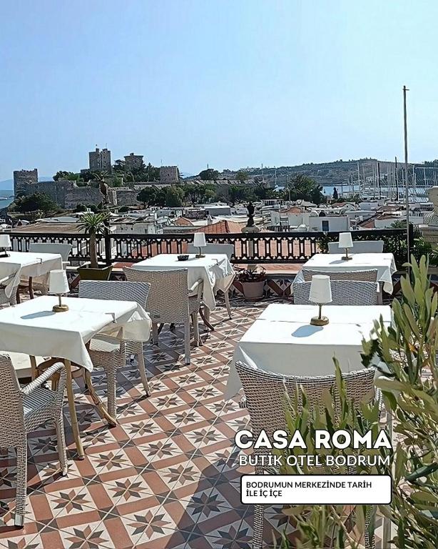 a patio with tables and chairs on a roof at Casa Roma Boutique Hotel in Bodrum City