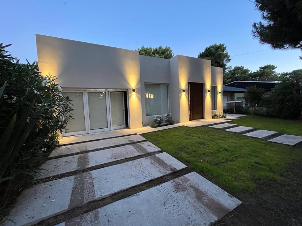 a large white house with a grass yard at Casa Marina in Monte Hermoso