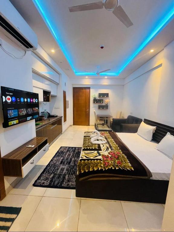 a hotel room with a bed and a television in it at Aawas studio in Noida