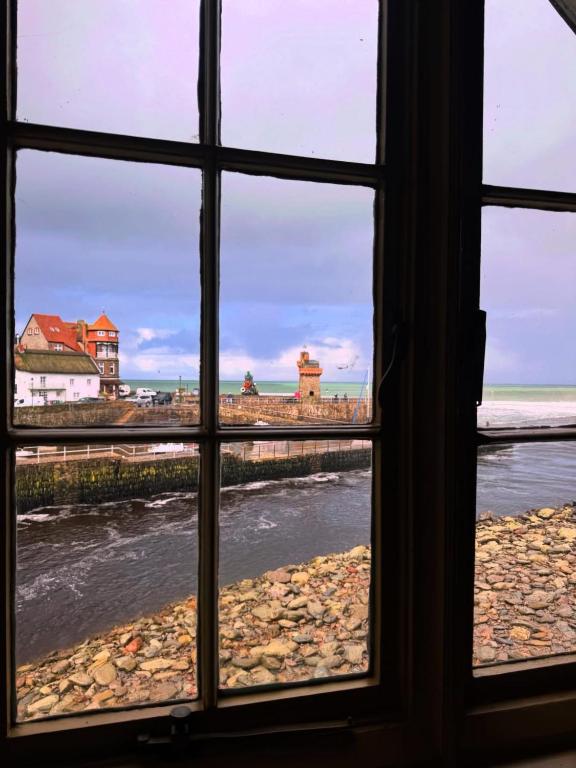 a view from a window looking out at the beach at Rock House Hotel in Lynmouth
