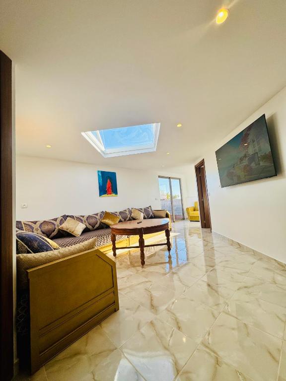 a living room with a couch and a skylight at بوابة الشمس 2 in Agadir