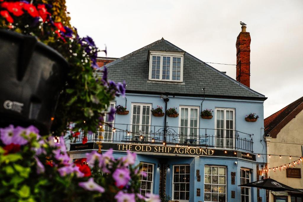 a blue building with a sign that reads the old ship aquarium at Old Ship Aground in Minehead