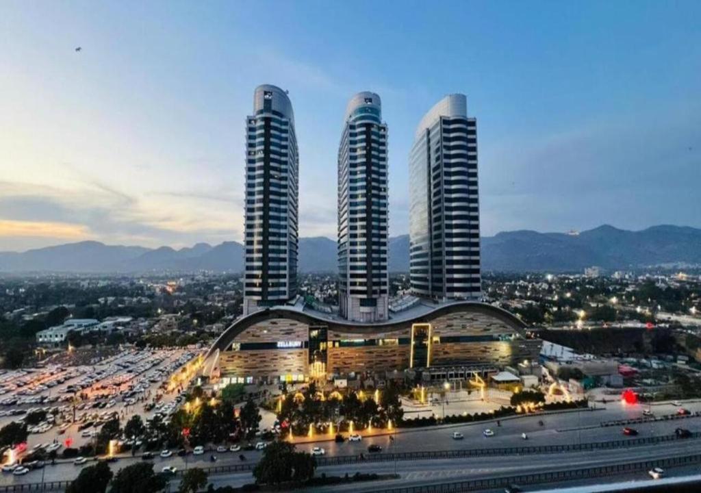 a group of three tall buildings in a city at The Premier Centauras in Islamabad