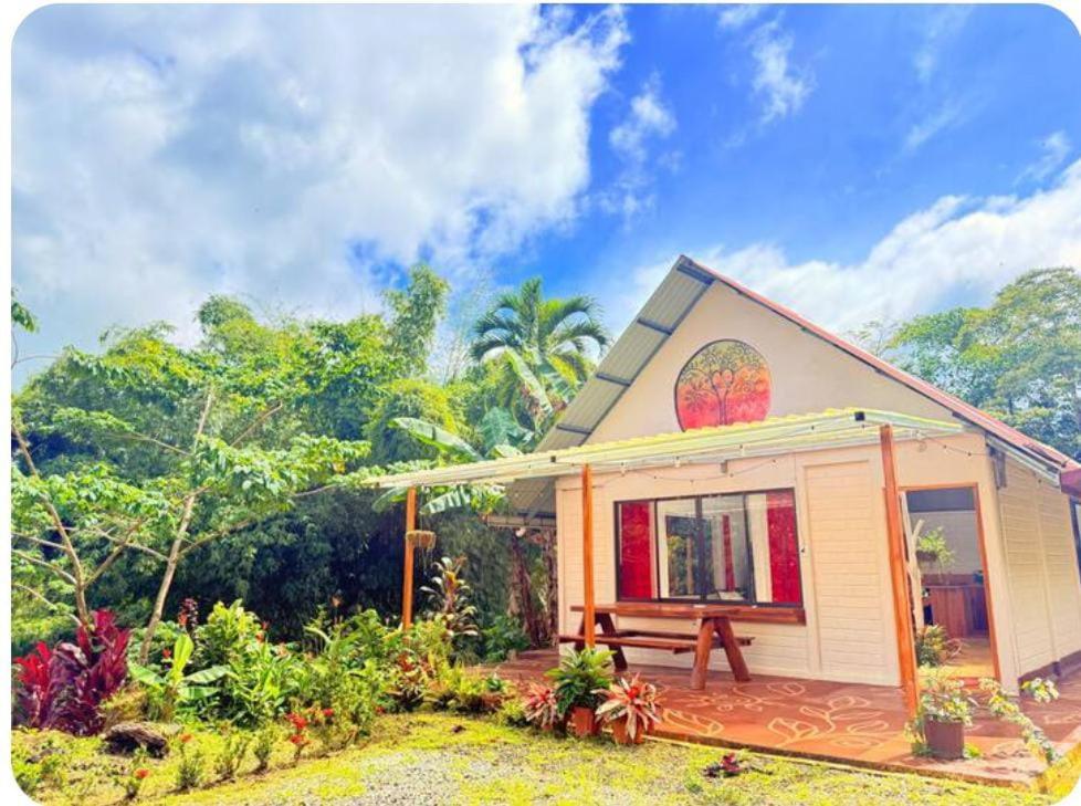 a small house with a bench in front of it at Mystic Solarium Private Indoor Pool in Chachagua