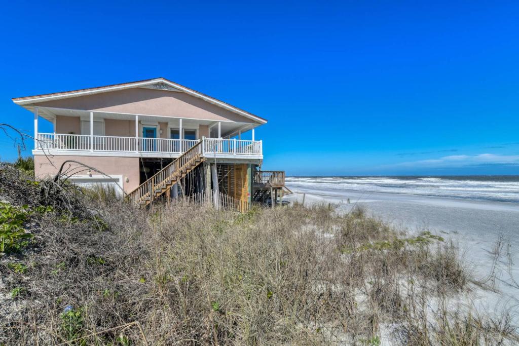a house on the beach next to the ocean at High Tide Paradise in St. Augustine