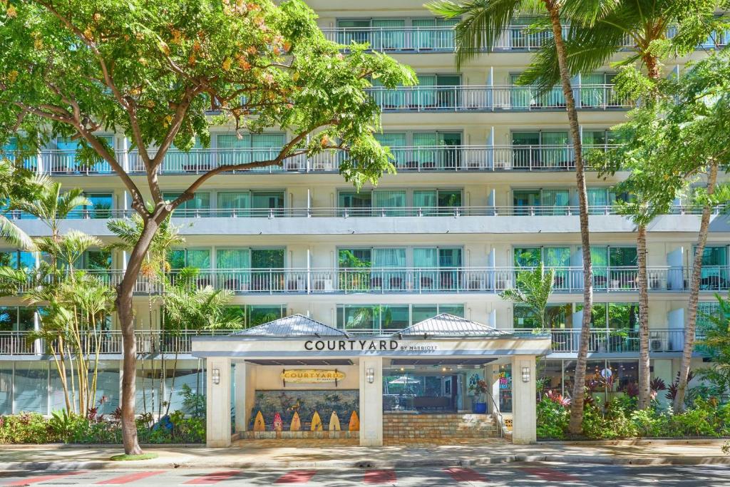 a hotel building with a sign in front of it at Courtyard by Marriott Waikiki Beach in Honolulu