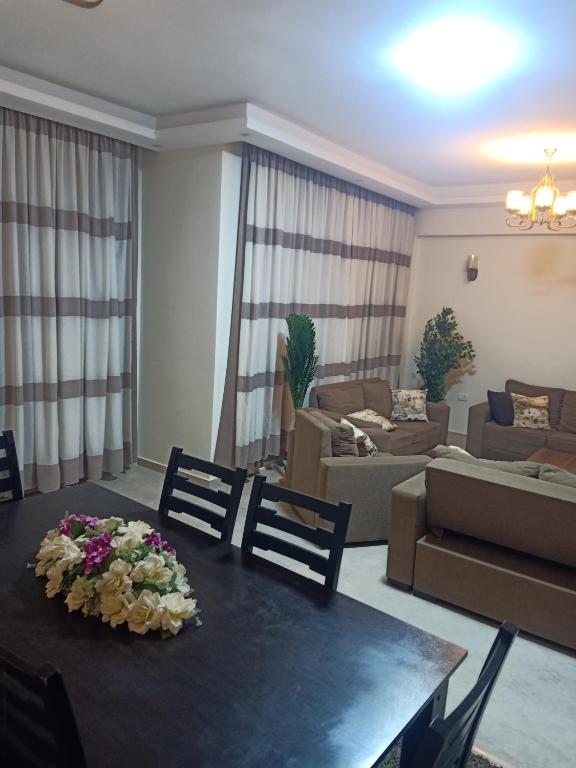 a living room with a table with flowers on it at Sky Star Villa 97 in Hurghada