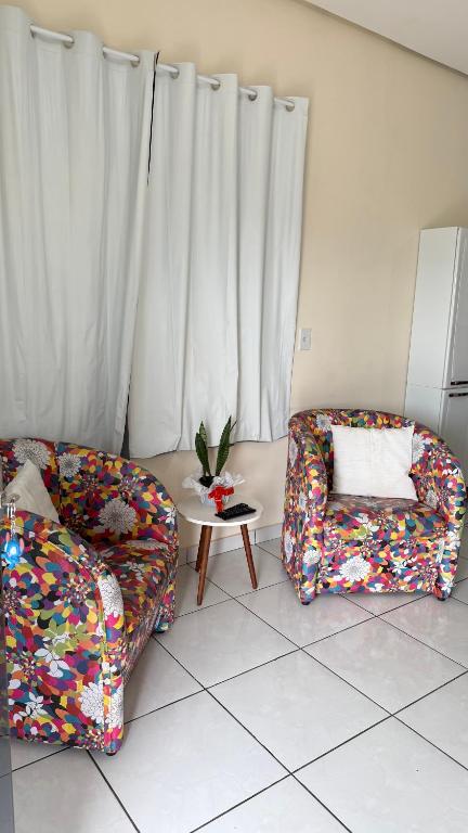 a living room with two couches and a table at Apartamento Aconchego da Serra Azul in Barra do Garças