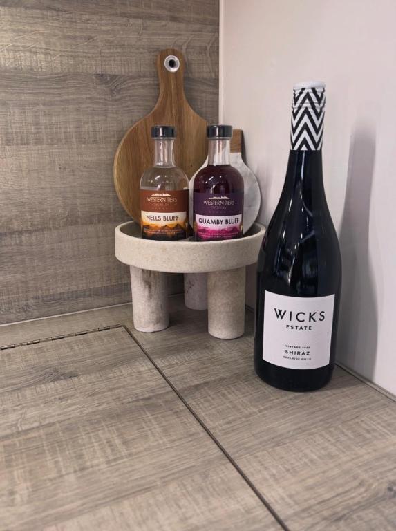 two bottles of wine sitting on a shelf in a room at Modern 4 Berth Van close to CBD in Newstead