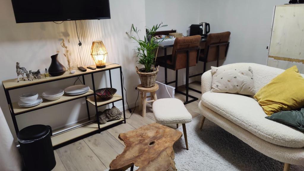 a living room with a couch and a table at Studio Zebra in Heikant