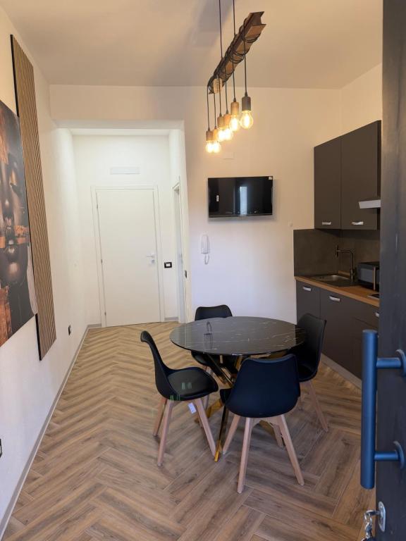 a kitchen and dining room with a table and chairs at Casa Amore Design - South Sardinia - in San Gavino Monreale