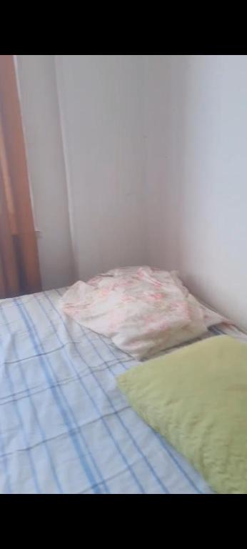 an unmade bed in a corner of a room at Pelourinho in Salvador