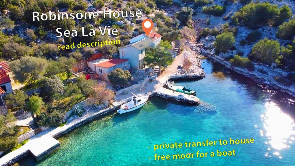 an aerial view of a river with a house and a boat at House Sea la vie in Murter