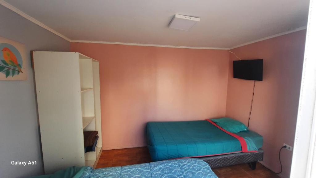 a small bedroom with a bed and a cabinet at Isabel de la serena in La Serena