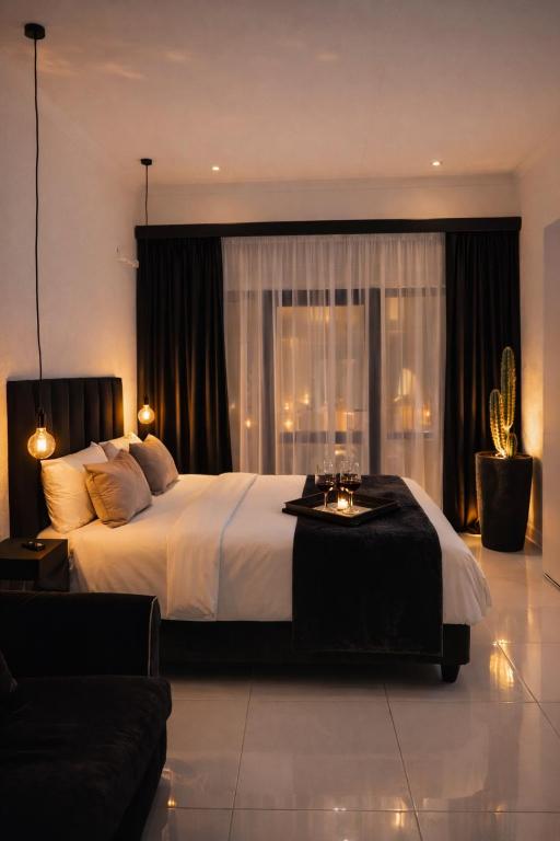 a bedroom with a large bed and a large window at Industrial CHIC Apartment 113 - Luxury City Escape, Washing Machine & Fast WiFi in Johannesburg