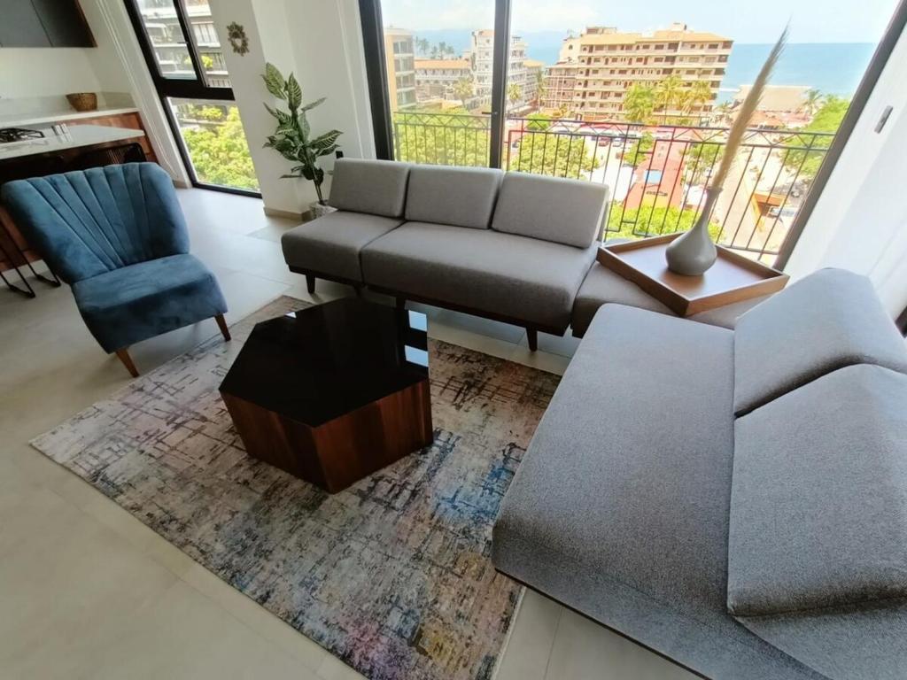 a living room with a couch and a chair at Perfect location 2 bedrooms Romantic Zone PV 601 in Puerto Vallarta
