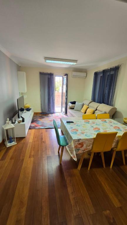a living room with a couch and a table and chairs at Jardim do Sol in Jardim do Mar