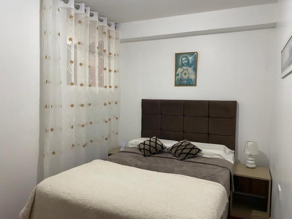 a bedroom with a bed in a white room at Minidepartamento en Huaral in Huaral