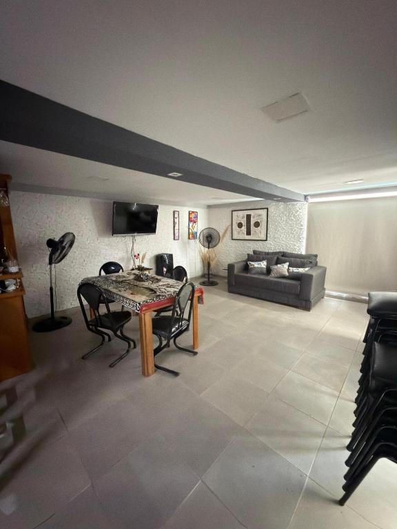 a living room with a table and a couch at Departamento b privado cerca arena Maipú p4 personas cochera in Maipú