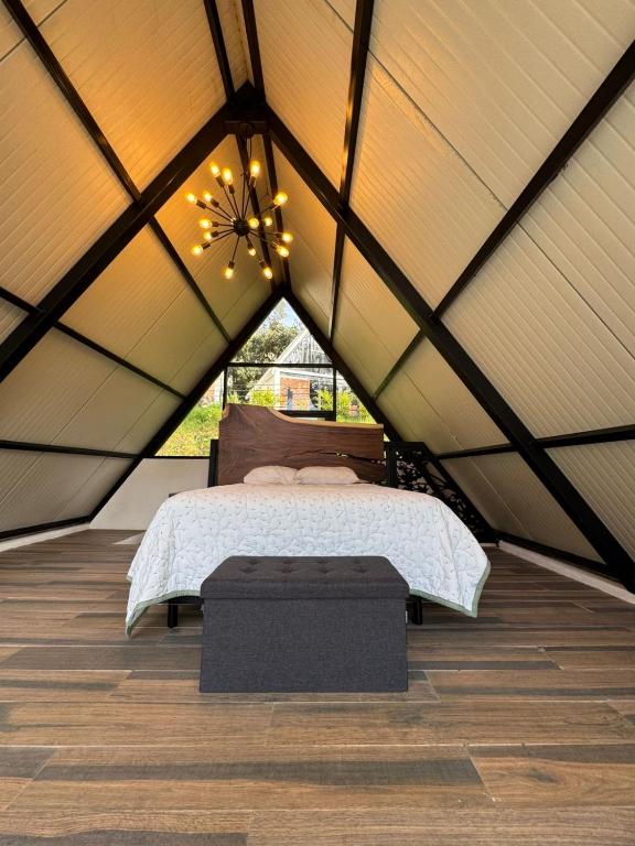 a bedroom in a tent with a bed and lights at Cabañas Los Angeles in Valle de Bravo