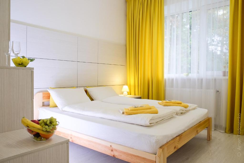 a bedroom with a bed with bananas on it at Hotel Black Cube in Tripolʼye