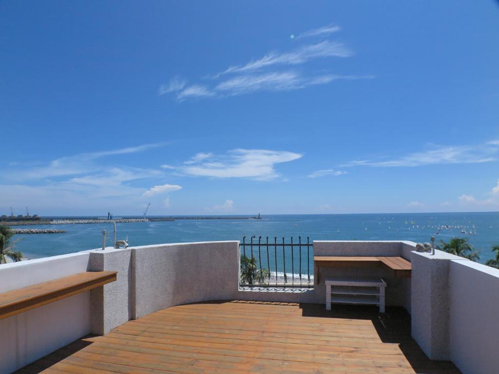 a balcony with a view of the ocean at White Sand Homestay in Hualien City