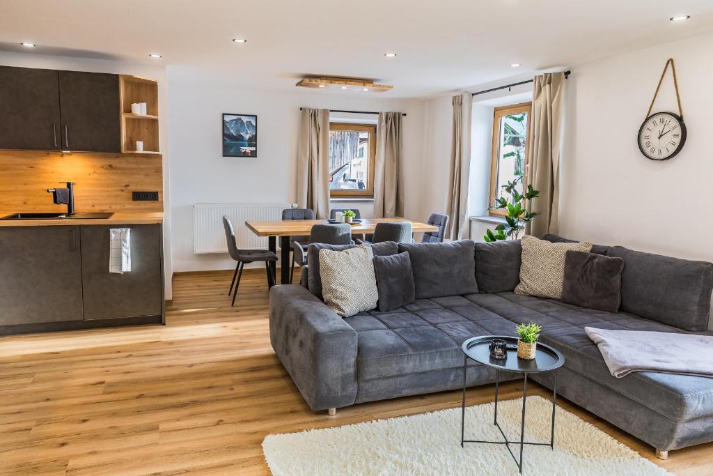 a living room with a couch and a table at Hotel Garni Edelweiß in Siegsdorf