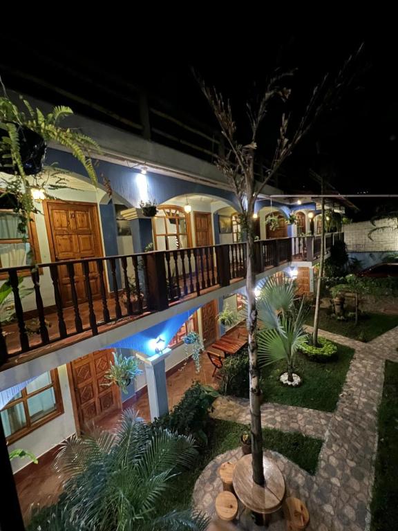 a house with a palm tree in the yard at night at Hotel Makani in Panajachel
