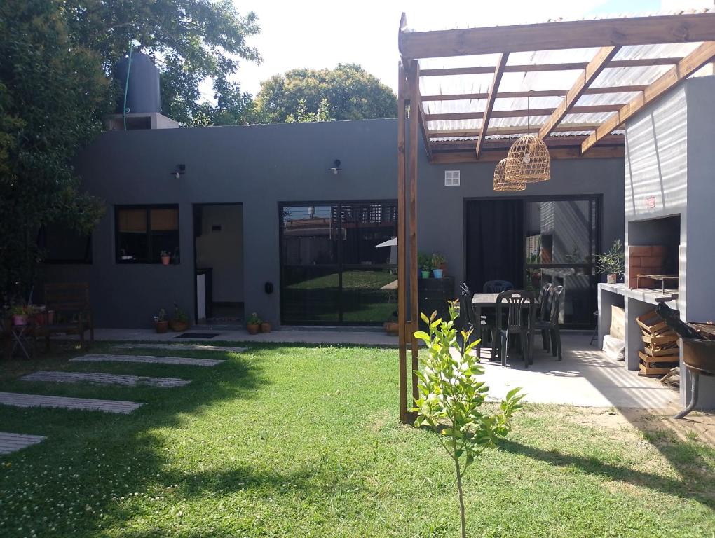 a house with a yard with a patio at Lo de Mili in General Juan Madariaga