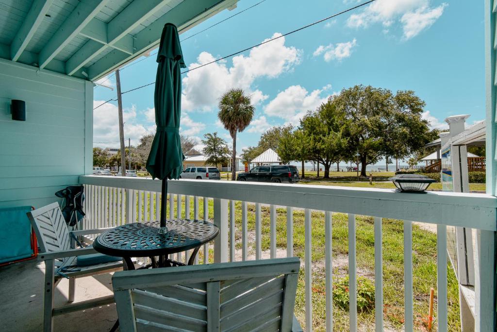 a patio with an umbrella and a table and a chair at Park Place Unit 130 in Cedar Key
